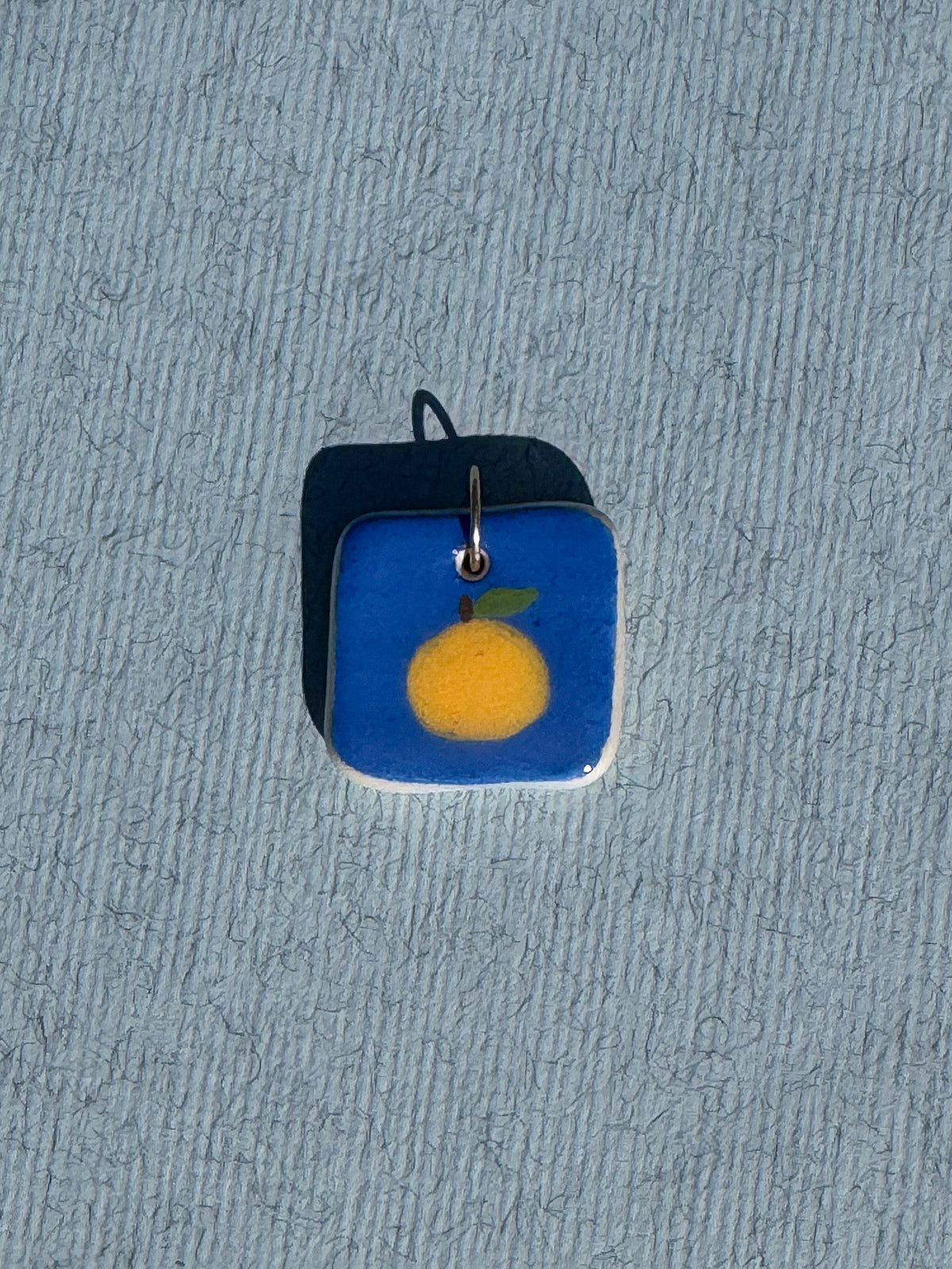 L'orange - Médaillon + Carte postale